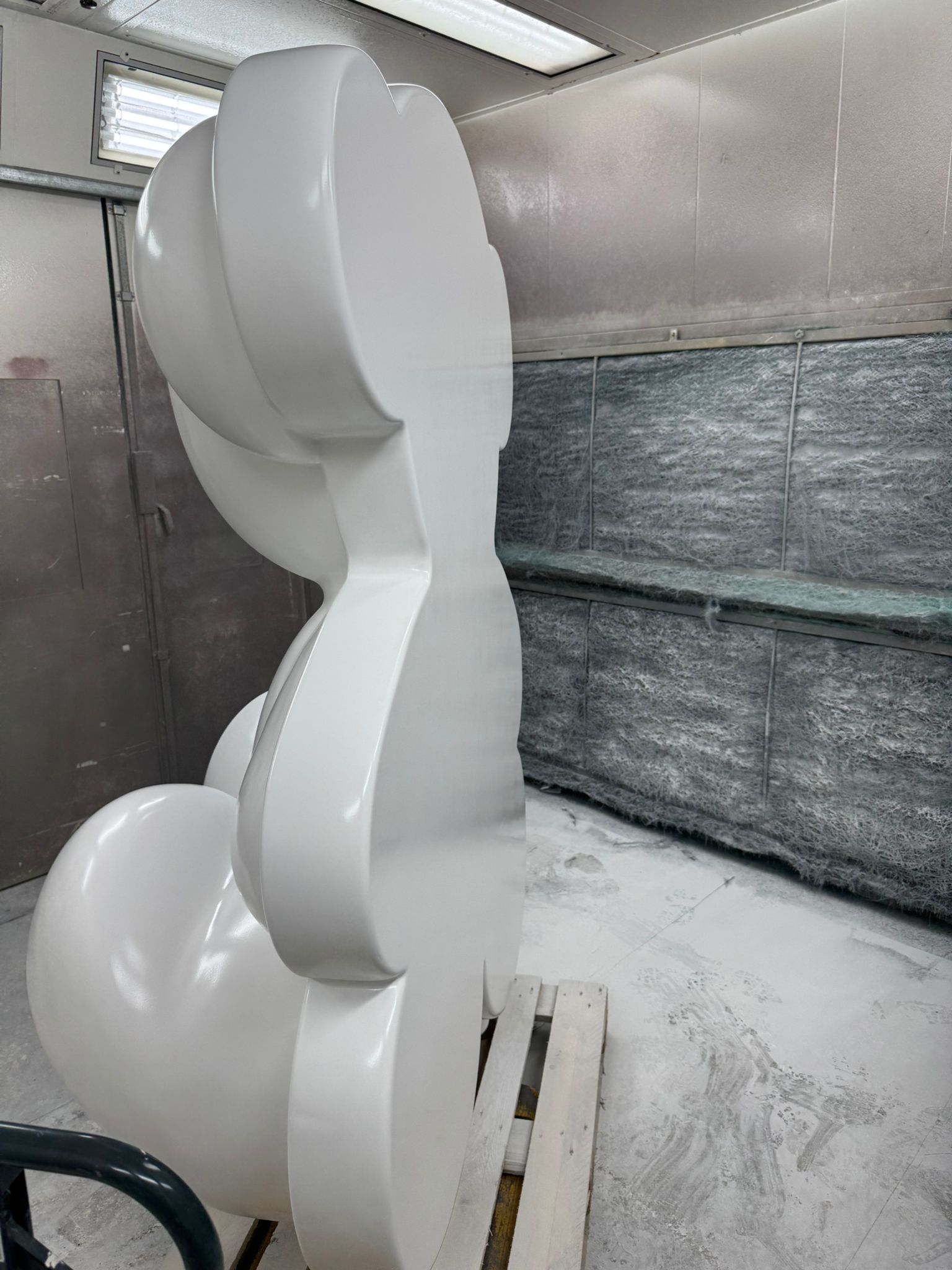 Lacquered sculpture drying in paint booth